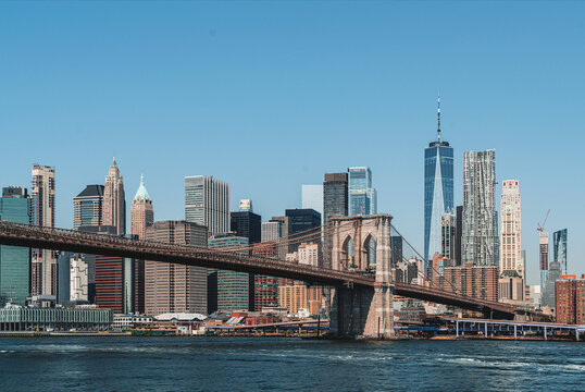 Brooklyn bridge and New York business centre, skyscrapers under blue sky