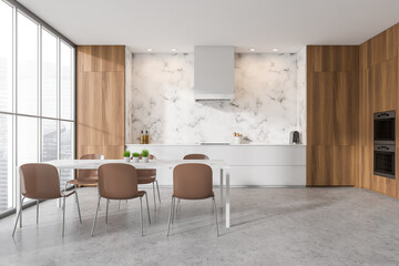 Bright kitchen room interior with panoramic window, table with chairs