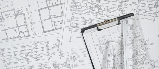 architect design working drawing sketch plans blueprints and making architectural construction model in architect studio,flat lay,architect background.
