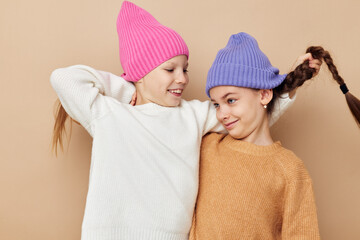 two funny little girls in colorful hats