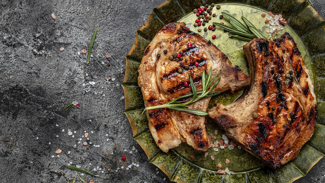 Pork chop steak on metal tray. Organic food. Fresh pork meat. Restaurant menu, dieting, cookbook recipe