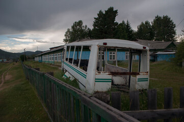 Old abandoned bus in village school