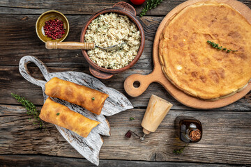 Savory crepe rolls, stuffed pancakes with ground meat filling. Traditional Russian Maslenitsa festival meal on wooden background