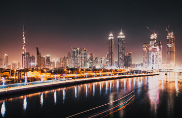 Fototapeta premium DUBAI, UAE - FEBRUARY 2018: Colorful sunset over Dubai Downtown skyscrapers and the newly built Tolerance bridge as viewed from the Dubai water canal.