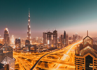 Fototapeta na wymiar DUBAI, UAE - FEBRUARY 2018: Dubai skyline at sunset with Burj Khalifa, the world tallest building and Sheikh Zayed road traffic