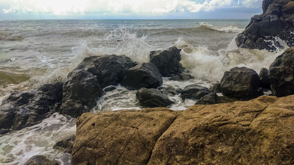 Rocky coast of the Black Sea during a storm in cloudy weather