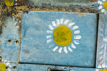 Beautiful blue grungy wooden wall with a hand painted flower