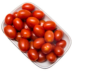 Red cherry tomatoes on the plate isolated on white background