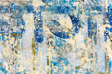Old grungy wall with peeling paint and plaster