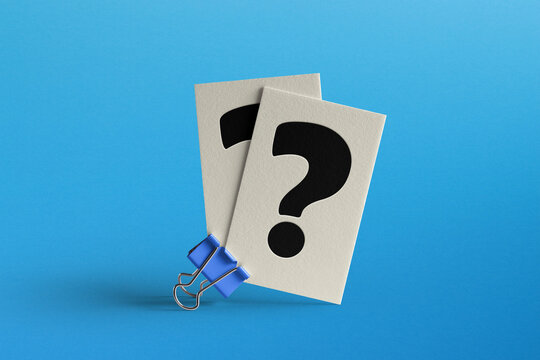 Binder clip with question mark on blue background