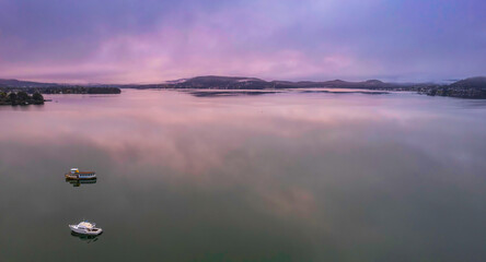 Cloud covered aerial waterscape with boats