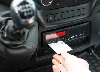 Driver pulls out the driver card from a digital tachograph