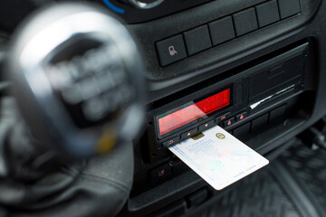 Digital tachograph in a van from an angle with ejected driver card - obrazy, fototapety, plakaty