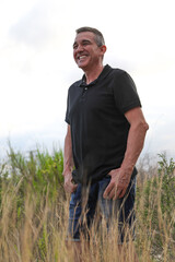 Naklejka na ściany i meble Handsome and healthy man who takes care of himself is 60 years old, in a field in Alicante 