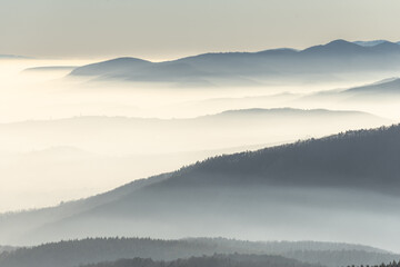 Silhouettes of mountains in the sea of fog in winter.