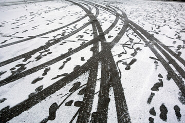 Tire marks on snowy asphalt