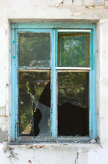 Old wooden broken window in a brick house