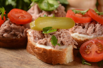 Open sandwich with canned tuna, cucumber, tomatoes, pickled cucumber