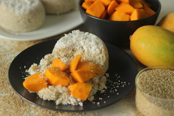 Steamed barnyard millet flour cake or barnyard millet puttu served with mango slices and plantains
