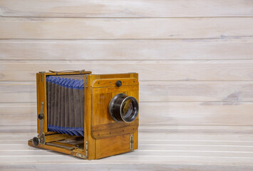Sarin wooden camera on a set wooden background