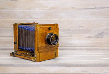 Sarin wooden camera on a set wooden background