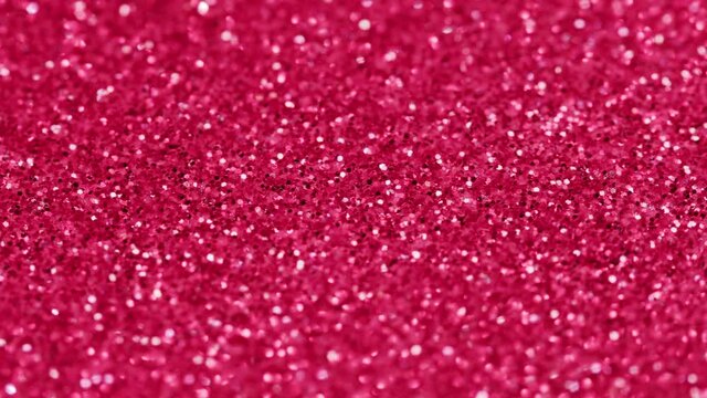 Pink glitter texture, bright shimmer close-up, shiny sparkle abstract background.