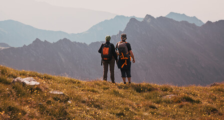 Fototapeta hiker couple enjoying high mountains view obraz