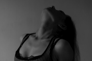 Beautiful long haired young woman in sexy underwear with throwing head back. Concept of sexuality,...