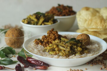 Rice porridge or Kanji along with spicy coconut red chilly chutney, stir fried boiled red cowpea beans and stir fried raw banana slices. A favourite meal of Kerala