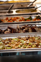 hot food in aluminium bowls at the buffet
