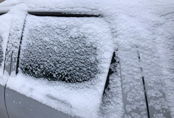 Close up frozen winter car covered snow, view side window on snowy background