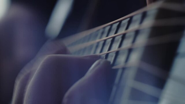 The musician plays the acoustic guitar. Closeup of the right hand. Macro shooting. Depth of field