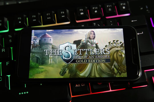 Viersen, Germany - January 9. 2022: Closeup of mobile phone with logo lettering of pc game the settlers on computer keyboard