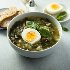 Traditional homemade green soup with hard boiled eggs	