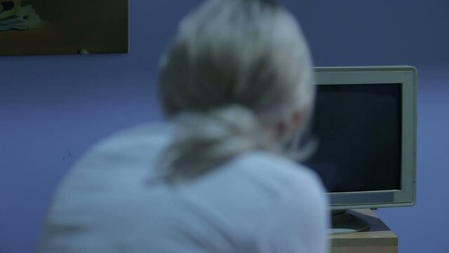 Doctor in operating room trying to help on intensive care patient, use defibrillator electrical device to shock heart. Looks at the monitor with vital data