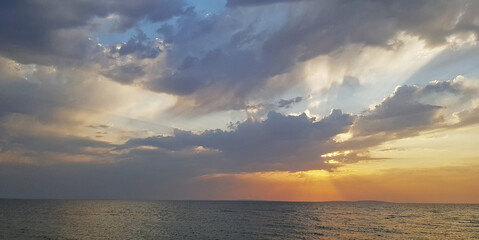 Naklejka na ściany i meble Evening sunset windy sky on the sea