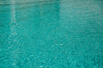 Wave pattern. Close-up of the water surface of the pool close up. Crystal texture