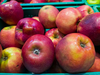 Fresh apples are in a box in the store