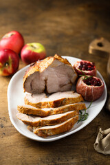 Fototapeta na wymiar Homemade roasted pork with apples and cranberry