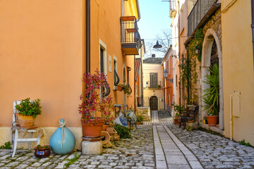 Fototapeta na wymiar A street among the characteristic houses of Buonalbergo, a mountain village in the province of Benevento, Italy.