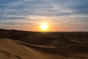 Fototapeta na wymiar Sunset in the desert over the dunes in Sharjah, UAE