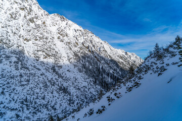 Mountain winter landscape in the Tatras, mountain view covered with snow in frosty sunny weather