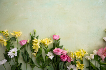 Easter green background with flowers top view