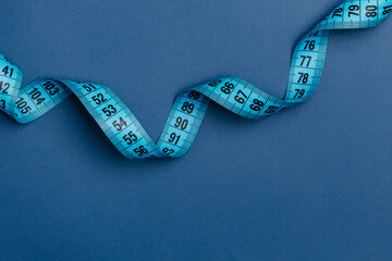 Centimeter blue ribbon spirals against a blue background.