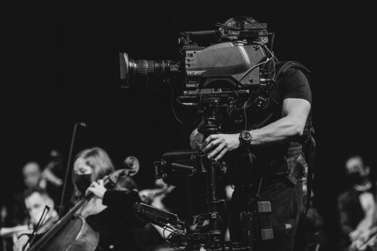 Professional steadicam (gimbal) operator filming a classical music concert.