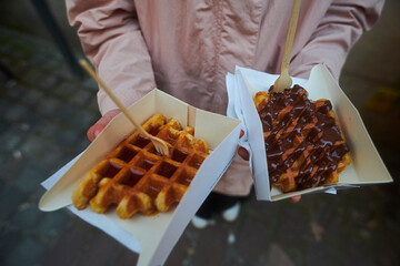 Close up of a freshly baked waffle in the historic city centre of Bruges in Belgium