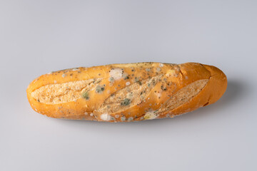 Moldy bread on blurry background. food fungus. Dirty food that is unappetizing.