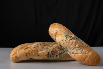 Moldy bread on blurry background. food fungus. Dirty food that is unappetizing.