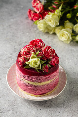  Black currant mousse cake decorated fresh roses. Delicious dessert 