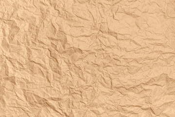 Fototapeta premium Crumpled brown kraft paper background. Abstract texture for design. Copy space for ad or announcement. Top view.